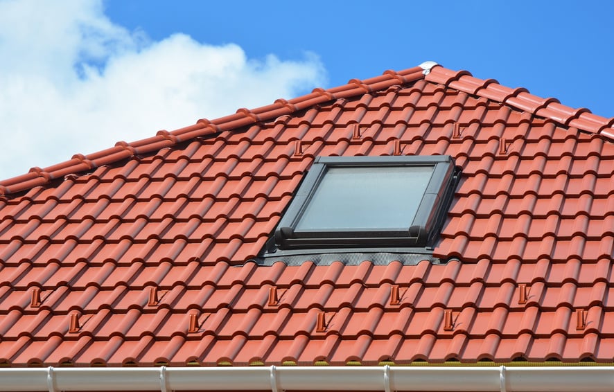 Skylight on red ceramic roof tiles  house roof. Modern Roof Skylight. Attic Skylights Home Design. Roofing Construction. Clay Roof Tiles, Clay Tiles, Clay Roofing. Tile roof.